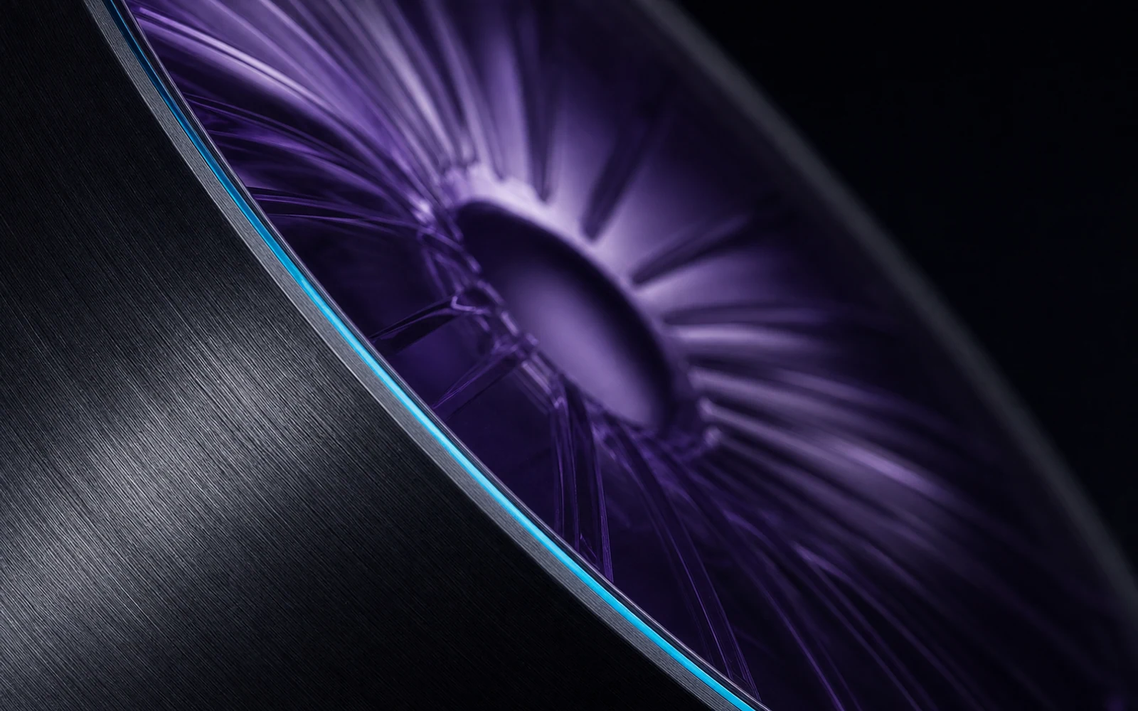Macro detail of brushed dark aluminum meeting a translucent violet acoustic surface with a cyan edge.